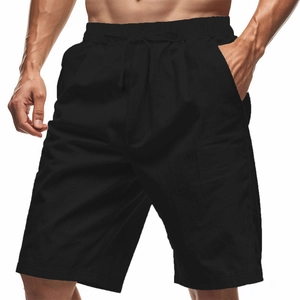 Detail of men's black drawstring shorts showing cotton linen texture and side pockets