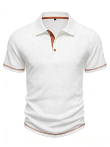 Detail of white polo shirt showing striped texture and brown contrast piping on collar