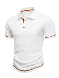 Detail of white waffle knit polo shirt with brown contrast piping and buttoned collar