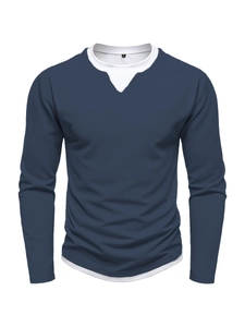 Close-up of navy waffle knit long sleeve shirt with white layered collar and hem detail