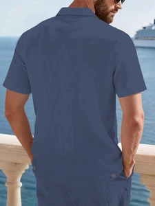 Detailed texture of blue linen shirt with decorative buttons on a seaside cruise deck