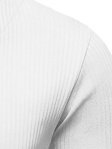 Close-up of white knitted sweater fabric showing vertical stripe texture and seam detail