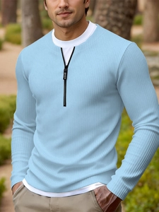 Detail of light blue ribbed knit sweater with a white fake two-piece zipper collar