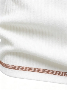 Close-up of white ribbed knit fabric with precise brown double-stitched hem detail