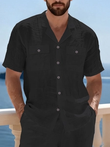 Close-up of black linen blend shirt with classic collar and double front pockets