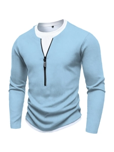 Detail of light blue knit Polo with zipper closure and white faux layer neckline