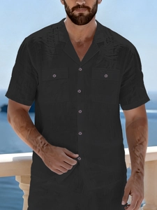 Detail of black linen shirt showing double chest pockets and retro Cuban collar design