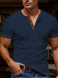 Detail of navy vertical ribbed knit polo with brown leather trim on the placket and collar