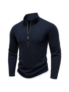 Detail of navy half-zip knit sweater showing ribbed texture and zipper pull design