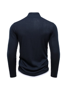 Detail of navy blue half-zip knit sweater showing ribbed texture and layered hemline