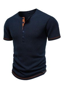 Detailed view of men's navy blue vertical ribbed Henley shirt with brown contrast stitching