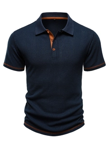 Detail of navy polo shirt with vertical stripes and brown contrast stitching on collar