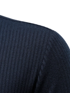 Detail view of navy blue half-zip sweater showing ribbed texture and shoulder seam quality