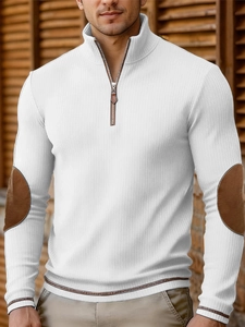 Detail of white ribbed quarter-zip pullover showing elbow patches and leather zipper pull