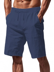 Detailed shot of navy cotton linen shorts showing the elastic waistband and drawstring detail
