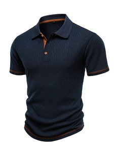 Detail of navy knit polo shirt showing orange contrast stitching and ribbed texture