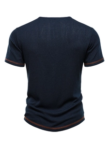 Detail of navy blue ribbed knit texture with orange contrast stitching on men's T-shirt