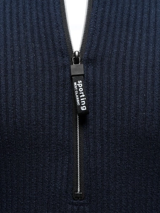 Detail of the navy blue knit sweater featuring half-zip collar and textured ribbed fabric