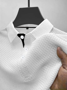 Close-up of white waffle knit polo shirt showing fabric texture and buttoned collar