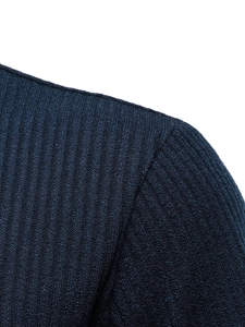 Macro detail of vertical ribbed texture and shoulder stitching on navy blue knit t-shirt