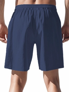 Detail view of the elastic waistband and breathable fabric on navy cotton linen shorts