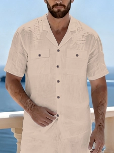 Detail of men's linen beach shirt featuring a Cuban collar and dual chest utility pockets