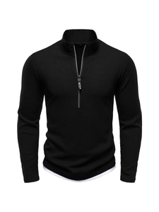 Detail of men's black knit sweater featuring half-zip collar and vertical ribbed texture