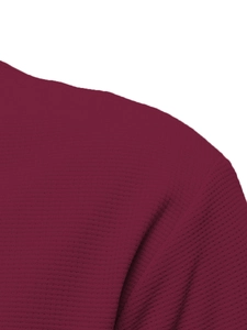 Detail shot of men's waffle knit long sleeve top showing dark burgundy fabric texture