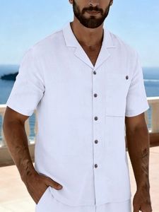 Detail of white linen beach shirt featuring wooden buttons and a front chest pocket