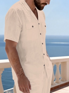 Detail of linen texture shirt with camp collar and dual chest flap pockets on beach balcony