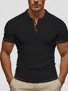 Detail of black polo shirt showing vertical ribbed texture and brown resin buttons