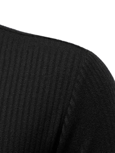 Close-up of black half-zip sweater showing detailed vertical ribbed knit fabric texture