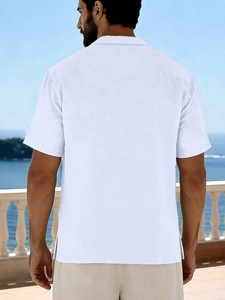 Rear view of men's white linen beach shirt with Cuban collar and side slit detail