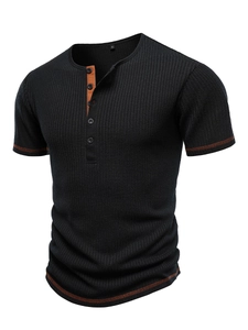Detail of black ribbed Henley T-shirt with orange contrast stitching and button placket