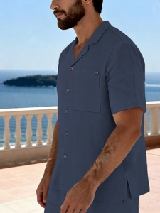 Detailed texture of dark blue linen beach shirt with vintage collar and chest pocket