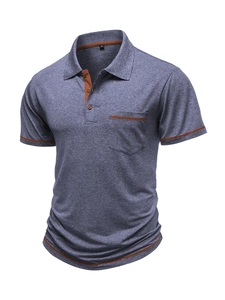 Detail of the blue-grey polo shirt showing brown collar trim and chest pocket accents