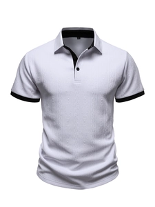 Close-up of white knit polo shirt with black contrast trim and textured diamond pattern