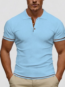 Detail of light blue ribbed knit polo shirt featuring brown contrast trims and buttons