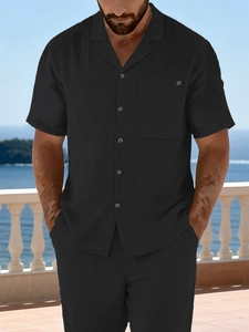 Men's casual black short sleeve linen shirt set with pocket shown on a sunny beach balcony