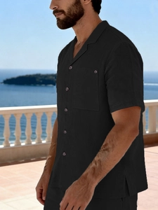 Close-up of black linen short-sleeve shirt with lapel collar and buttoned chest pocket