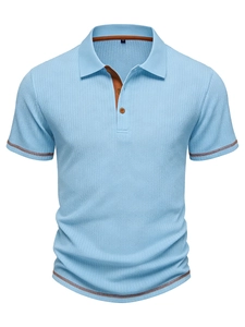 Detail of light blue polo shirt featuring vertical waffle texture and brown contrast piping