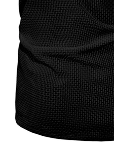 Close-up of black waffle knit fabric showing premium mesh texture on a men's polo shirt