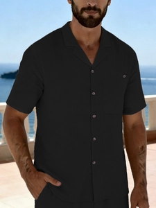 Detailed view of black linen beach shirt featuring classic camp collar and chest pocket