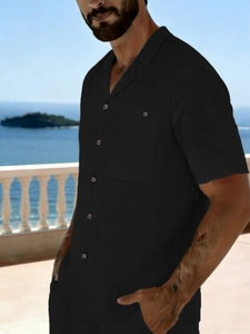 Detail of men black linen short sleeve shirt with Cuban collar and chest pocket