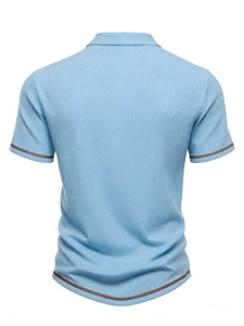 Detail view of light blue ribbed polo shirt showing the fabric texture and back seam