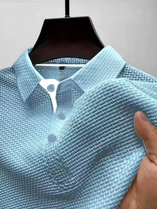 Detailed view of light blue polo shirt featuring premium 3D knit waffle texture fabric