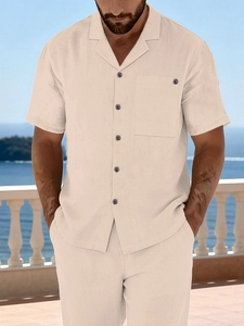 Detail of a beige men's linen short sleeve shirt with Cuban collar and buttoned chest pocket