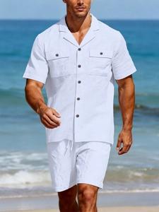 Detailed view of white linen beach set with Cuban collar and dual pocket shirt on beach