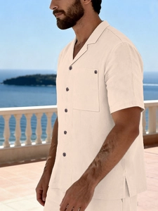 Detail of linen men's shirt showing breathable fabric texture and camp collar design