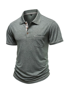 Detailed view of grey-green polo shirt collar with wood buttons and chest pocket